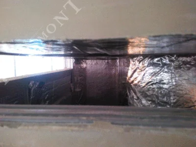 Obloge kamina - Intermont Zatvoreni prostor unutar obloge kamina. Spojevi izolacijskih ploča od kamene vune su zabrtvljeni sjajnom aluminijskom samoljepljivom trakom za osiguranje nepropusnosti i toplinske zaštite.